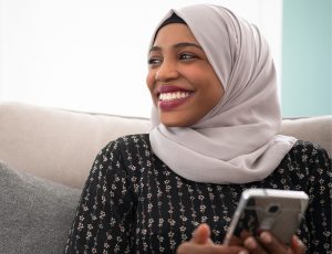 smiling black Muslim woman wearing a head dress