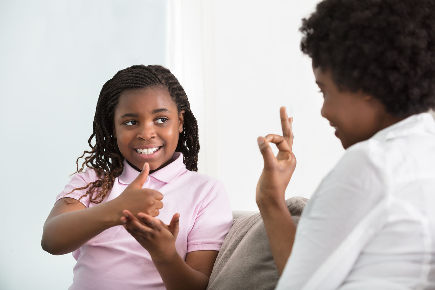 Smiling,Young,Mother,Learning,Sign,Language,To,Talk,With,Her